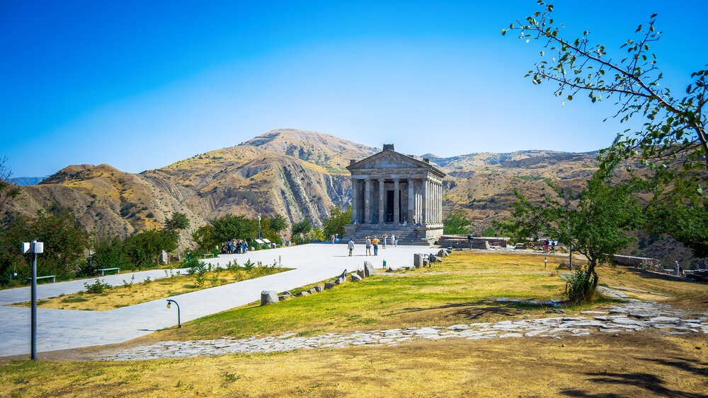 temple of garni in armenia with beautiful landscape of armenian countryside behind it