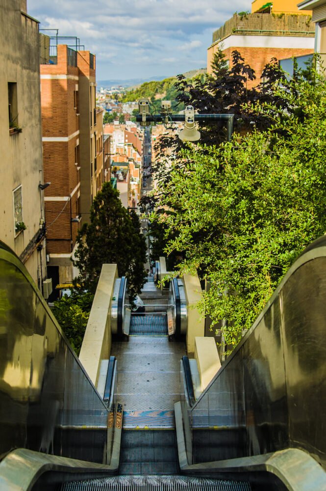 escalator view in barcelona with cameras and hill