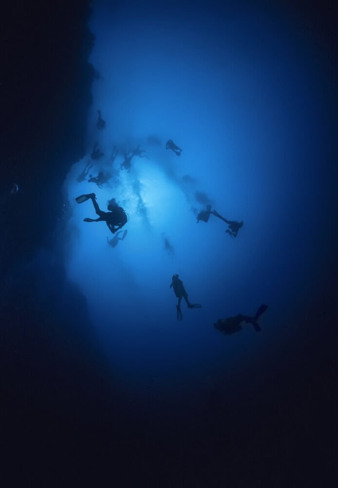 People diving deep in the Great Blue Hole in Belize