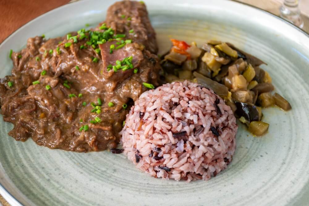 Dish Gardiane de Taureau, gardianne, or daube camarguaise bull slow cooked stew served with rice from Camargue with vegetables, tastes of Camargue, Provence