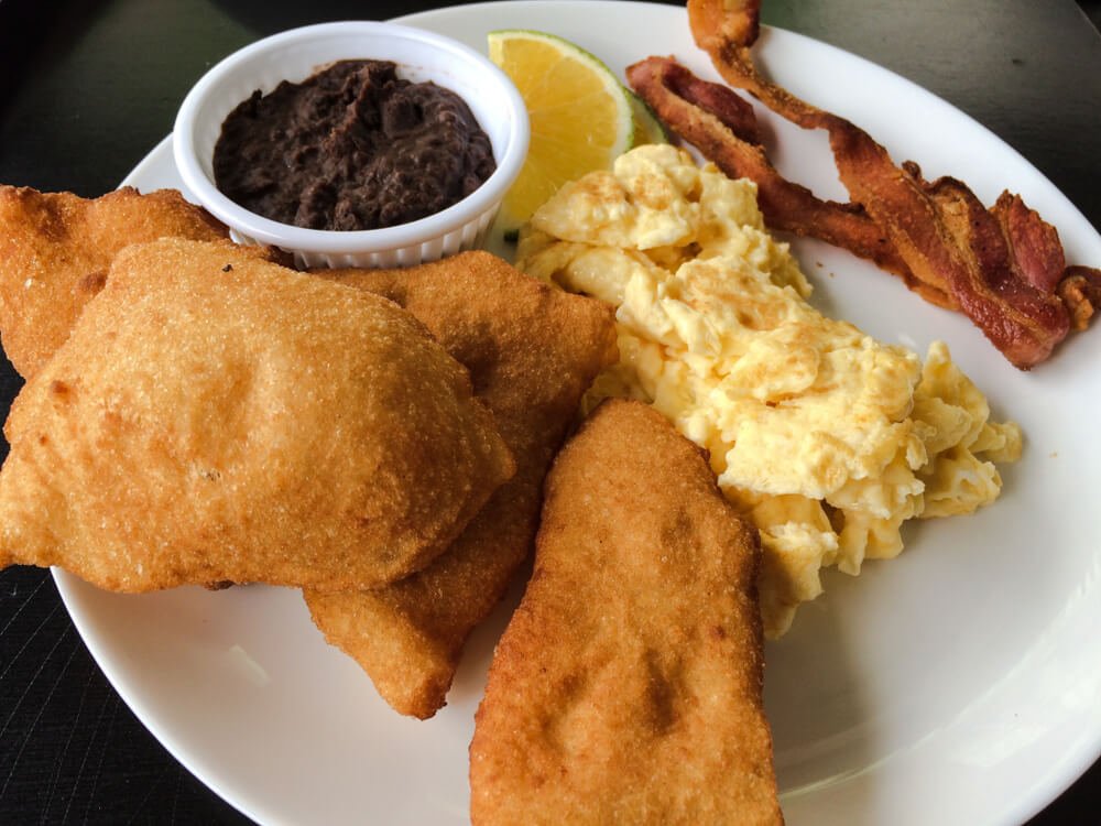 Traditional Belizean breakfast with fry jacks served in San Ignacio, Belize
