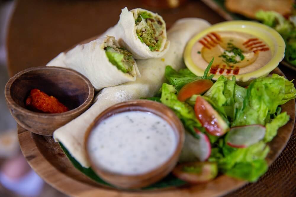 traditional lebanese food like a chicken wrap with hummus