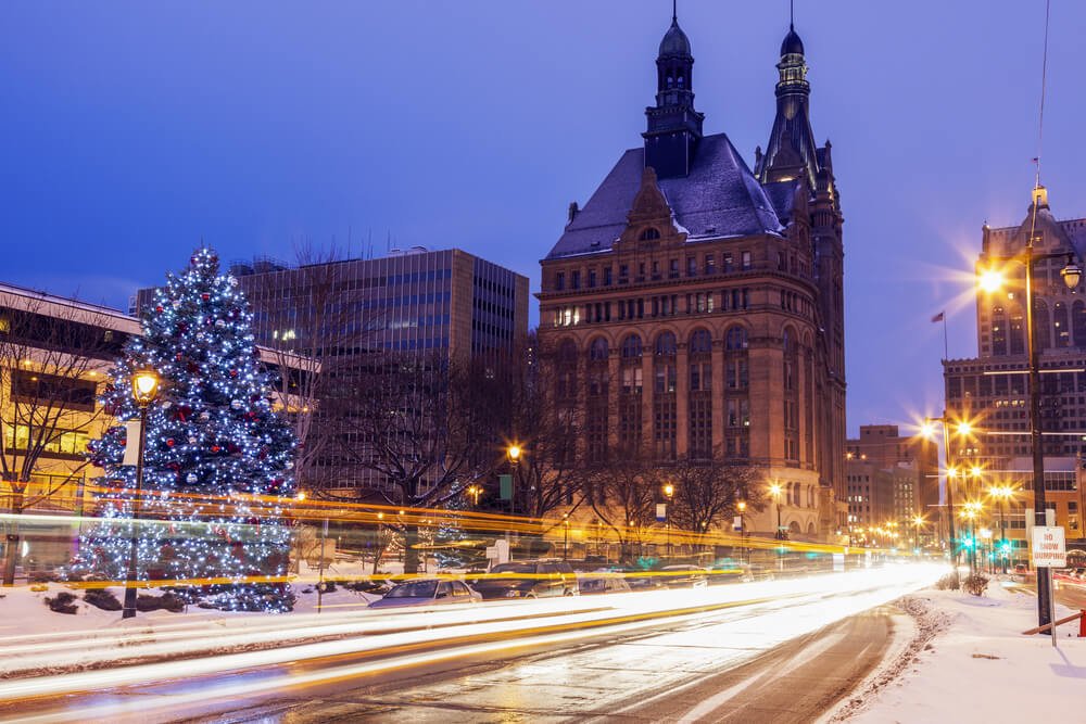 christmas tree and snowy landscape with light trails passing in milwaukee michigan