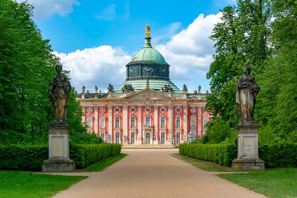 The red and white facade of the New Palace (Neues Palais) in Sanssouci park part of Potsdam
