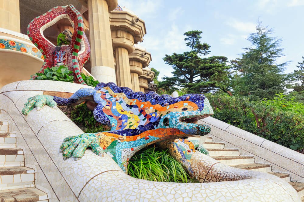 Park Guell in Barcelona. Frog sculture fountain at main entrance covered with pieces of colorful ceramic tile
