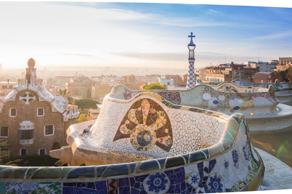 View of the city from Park Guell in Barcelona, with its mosaic serpentine bench and a view of the city of Barcelona