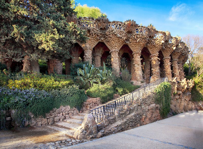 view of a section of parc guell with colonnades and nature mixed together in barcelona