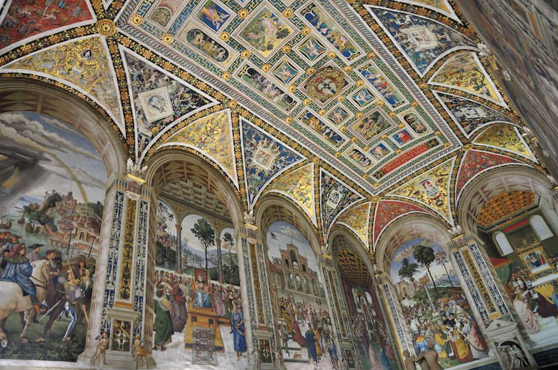 The ceiling of Siena Cathedral's ornate gold inlay and fresco work of the Piccolomini Library on full display