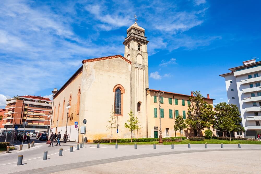 One of the buildings of Piazza Vittorio Emanuele square, the lovely beige colored St Anthony Abbey, a Catholic church in Pisa.