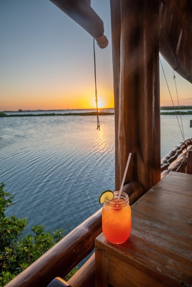 Sunset views while drinking a traditional Belize rum punch cocktail 