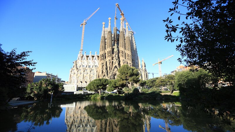 the sagrada familia of barcelona with water in the front