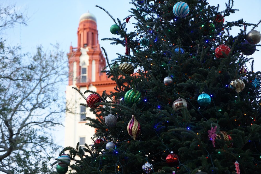 Saint Augustine's city Christmas Tree, decorated with the church tower behind it