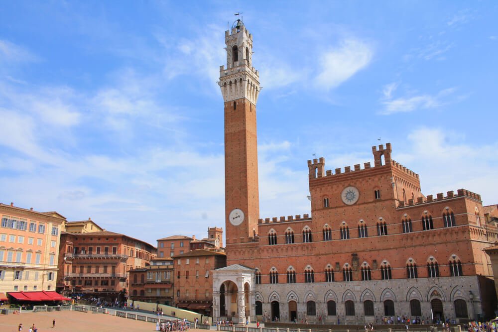 Sunny day in Siena, Piazza del Campo with the Pubblico palace and Mangia tower, two of the most famous spots on a Siena itinerary besides the Duomo