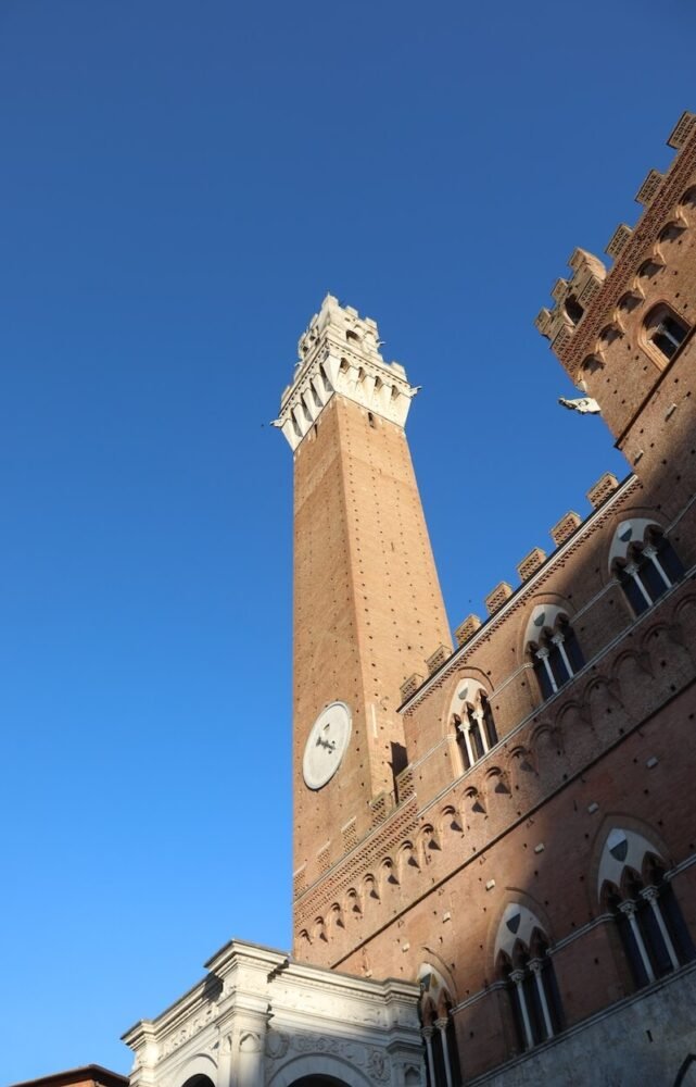 Close up on the ancient tower, torre del mangia, in Siena city center