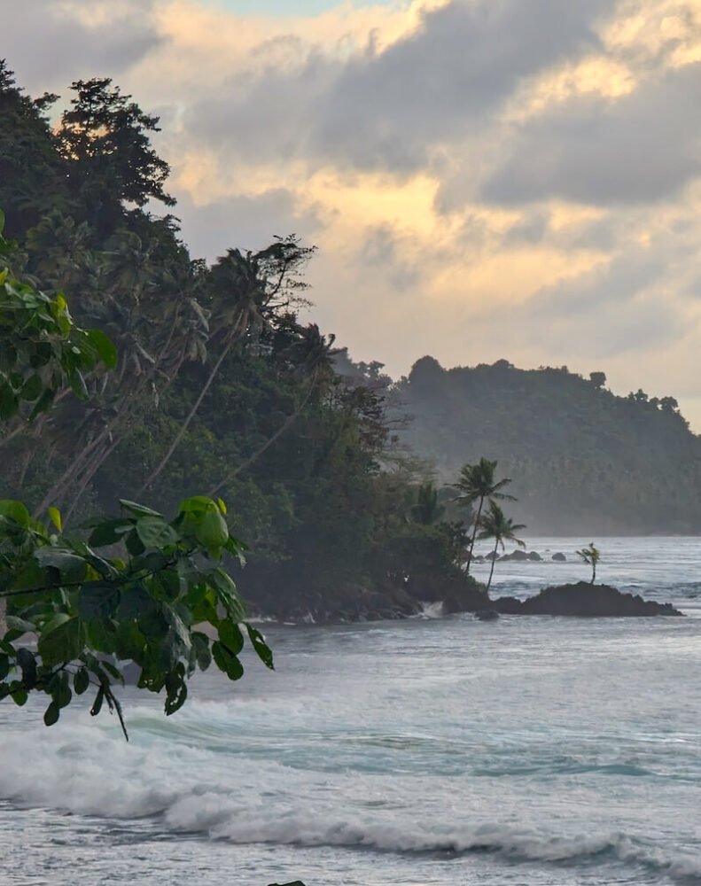 sunset colors in the sky with rugged landscape of taveuni coastline in lavena coastal walk