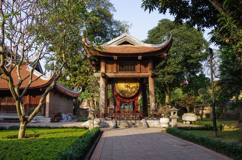 the temple of literature in hanoi with a pagoda and gold circle insignia