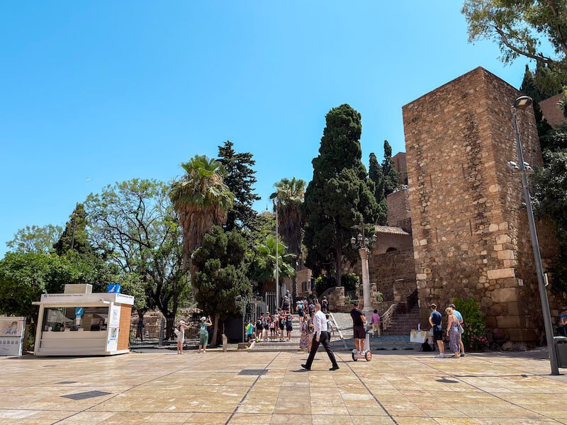 the area of the alcazaba on a sunny day in malaga in the south of spain which is a favorite winter destination for sun seeking europeans, with a bright blue sky and people enjoying the weather