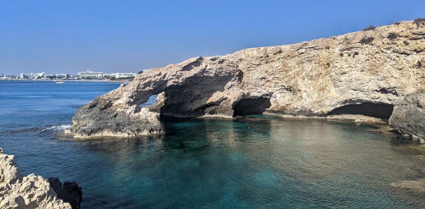 A gorgeous sea arch in the water in Cyprus with a stunning blue water view on a sunny day in January