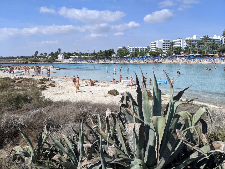 People enjoying the sunny weather in Cyprus wearing bathing suits and enjoying the day