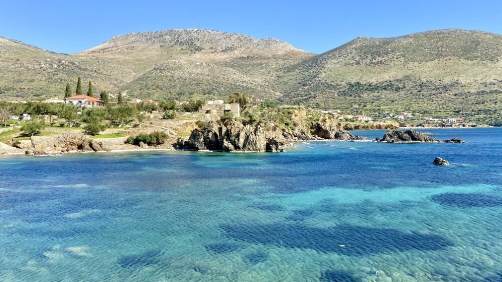 Looking at the brilliant blue waters in the region of Greece with coastal views and houses and hills