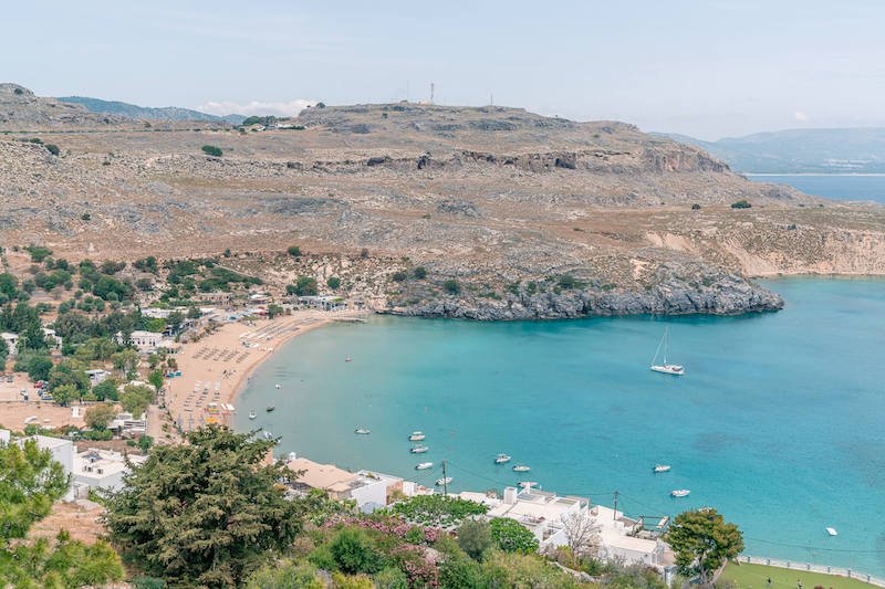 The beautiful Bay of Lindos while visiting Rhodes in the winter without the summer crowds. Gorgeous arid landscape and clear blue water.