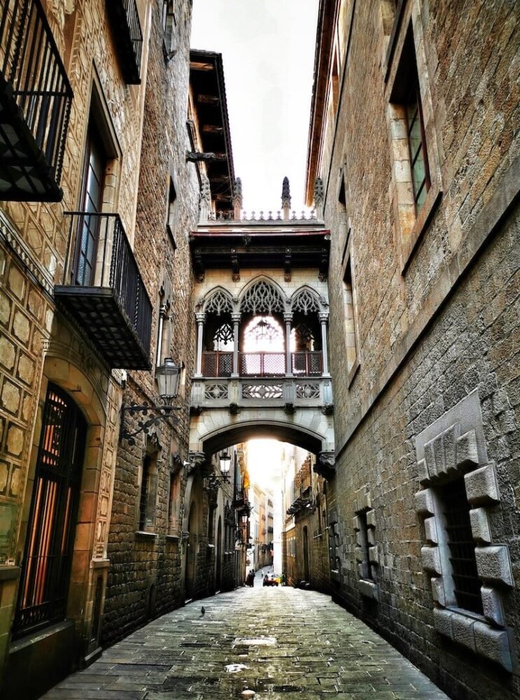 View of the Gothic Quarter of Barcelona with its arched architecture and its scenic medieval-looking buildings on a quiet day visiting Barcelona in January, a warm destination for Europe.