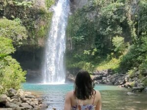 Allison Green in front of the waterfalls of Tavoro Falls
