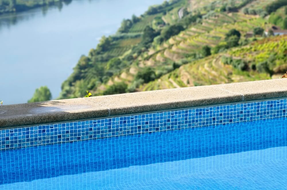 Close up of the edge of an infinity pool at a Douro Valley wine hotel in Portugal