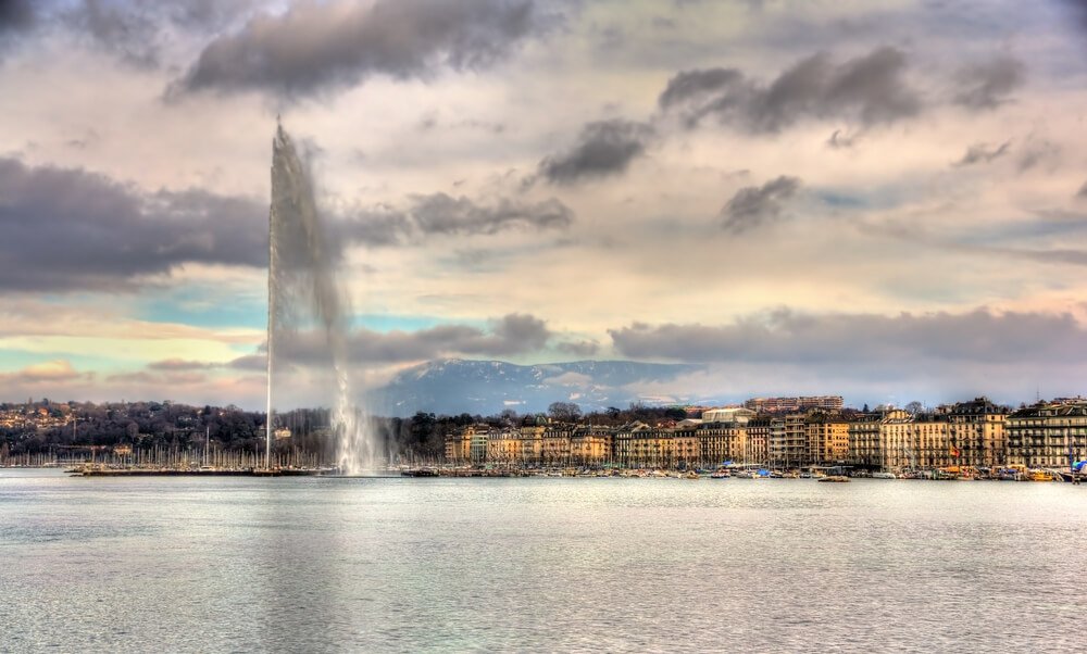 View of the Jet d'eau water fountain a symbol of geneva seen at sunset in the wintery months of geneva