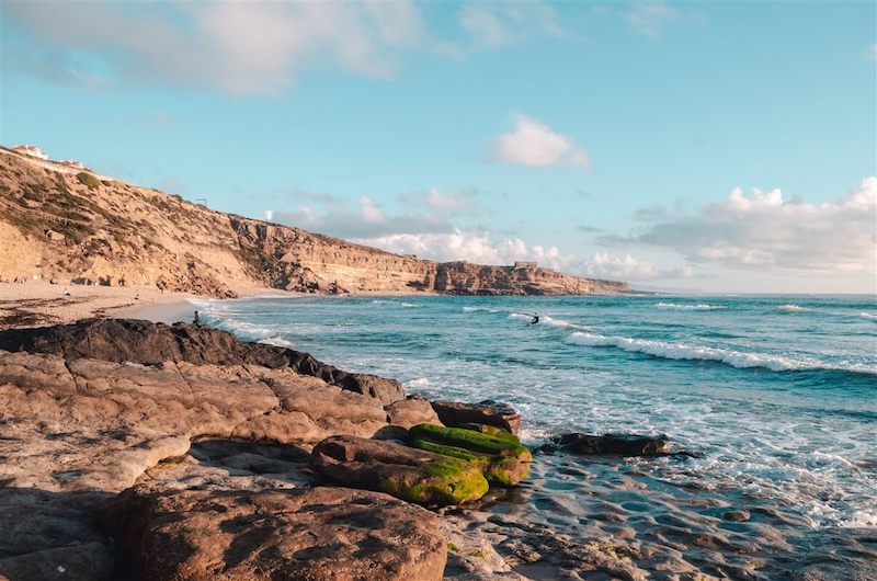 Watching people surf in the water in Ericeira Portugal in January