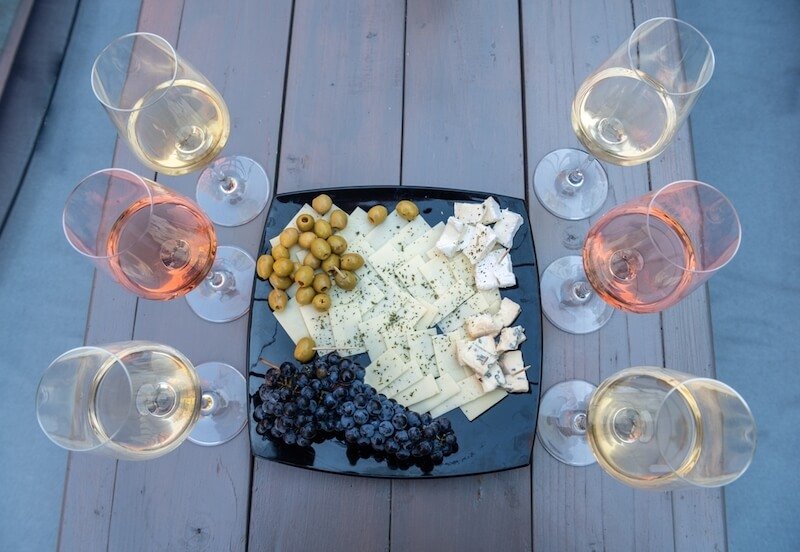 plate of different wine samples and tapas like cheese grapes and olives while on a wine tour from budapest