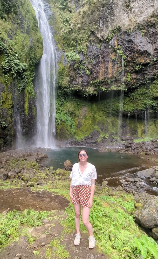Allison Green in her shoes and hiking clothes near savulelele waterfall