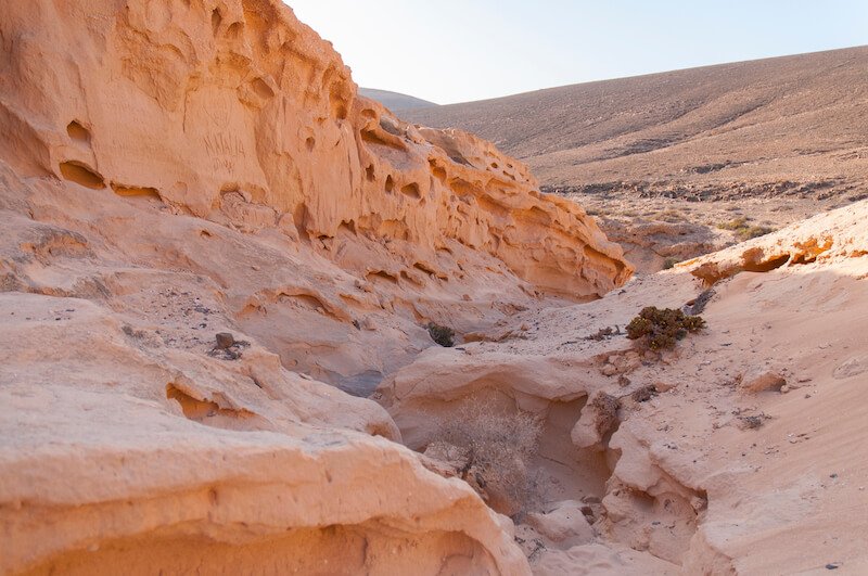 Smooth sandstone walls of Barranco de los Enamorados, a canyon with beautiful pinkish-orange landscape