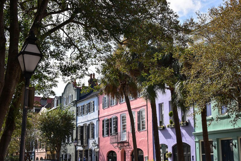 The famous rainbow row of pink, purple, green and blue houses in the historic downtown center of Charleston South Carolina 