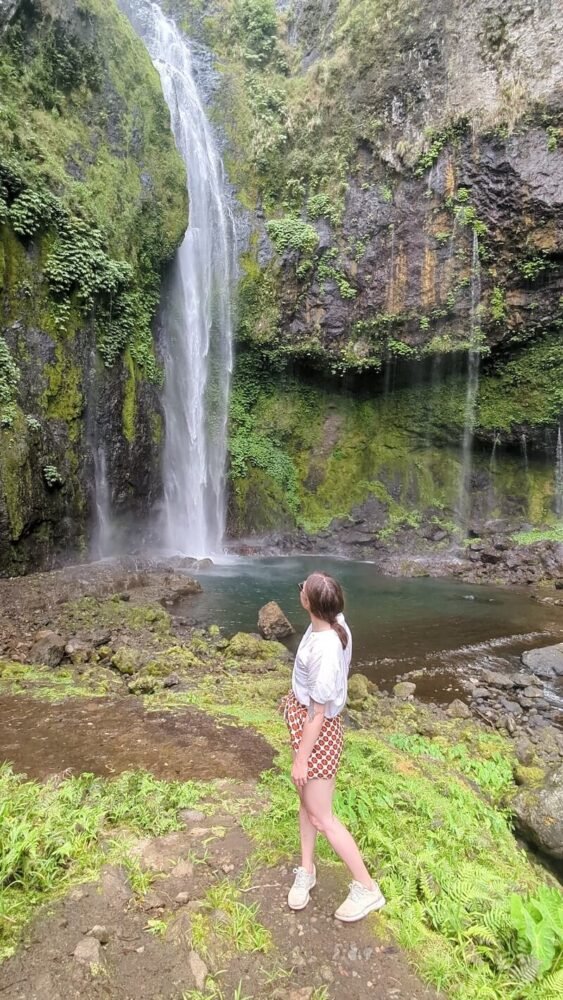 Allison Green in front of the waterfall at Savulelele Waterfall in Fiji