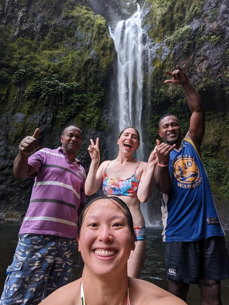 A selfie with our guides at Savulelele Waterfall in Fiji, two female travelers and two locals enjoying the waterfalls