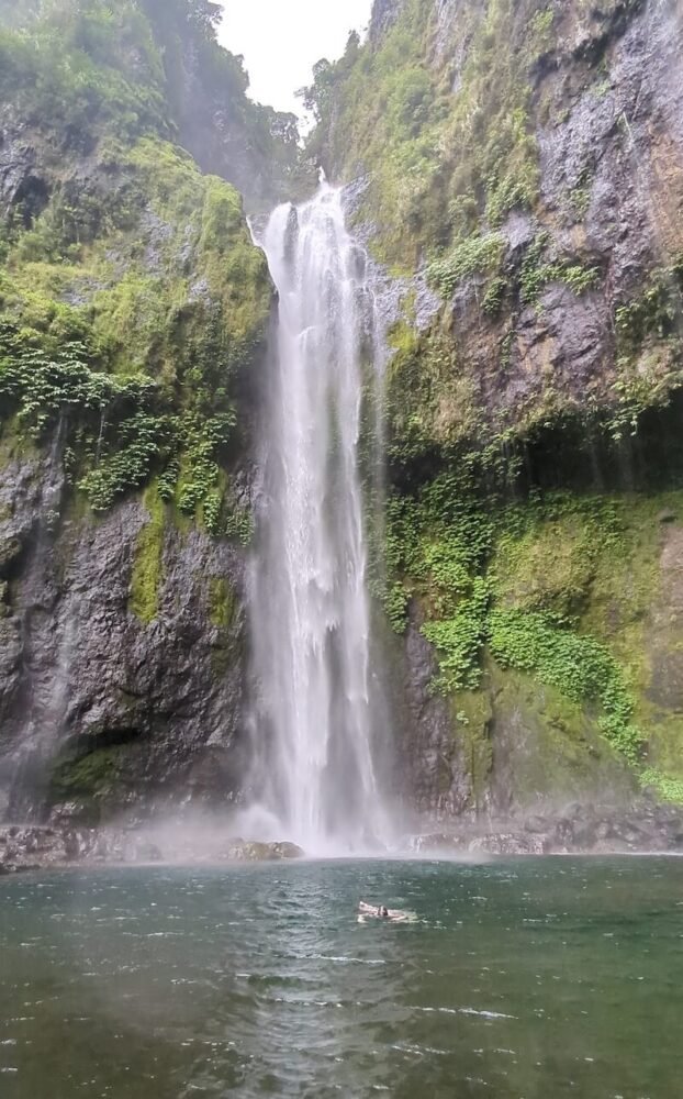 Allison Green swimming in the waters of the Savulelele Waterfall enjoying the cold rush of the water