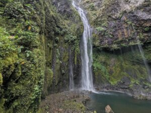 The waterfall of Savulelele as seen in a horizontal position with a calm swimming pool at the base of the falls