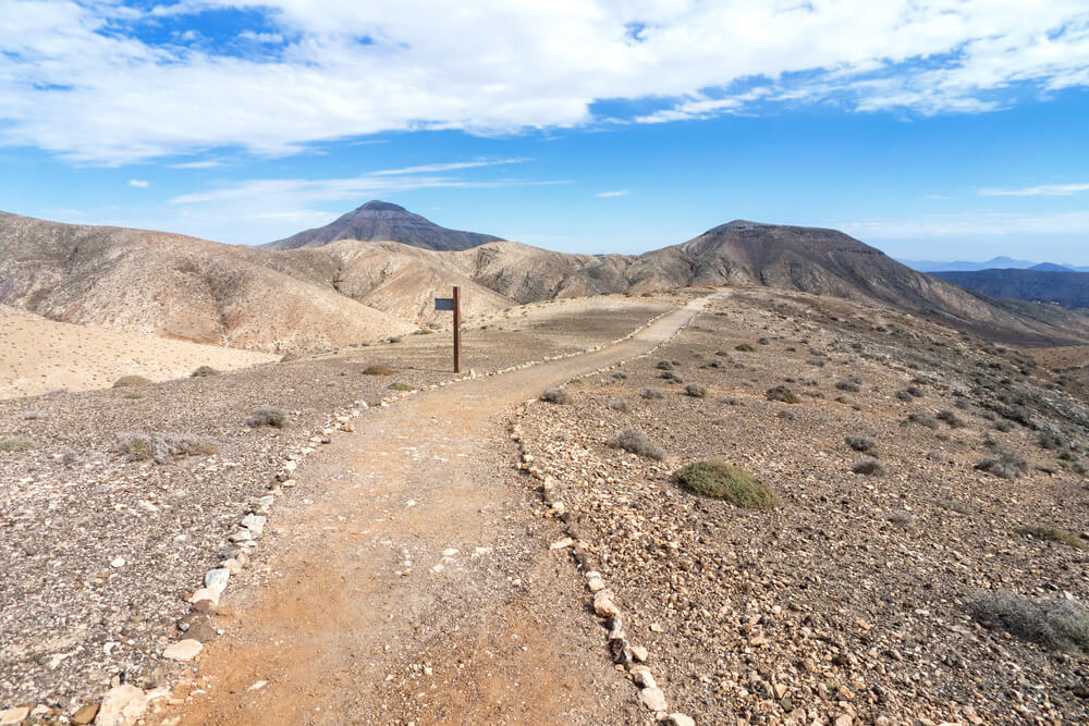 A signpost on a trail leading through the Cardon mountains in Fuerteventura, Canary Islands