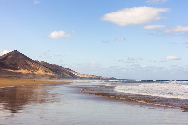 Beautiful beach in Cofete with lonely landscape with no one around on a partly cloudy day in a beautiful hiking weather day