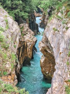 large gorge with a canyon in the middle of it, with a river in between, seen from above looking into the narrow slot between the two sides of the gorge