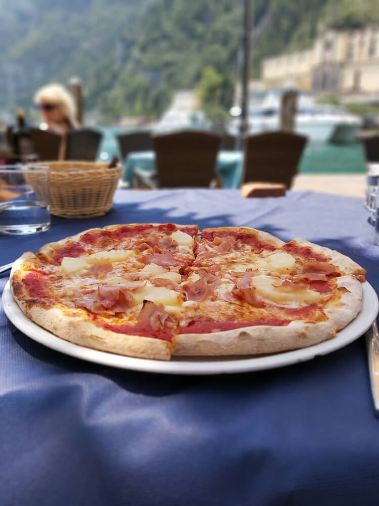 pizza on lake garda with a view of the lake in the background while enjoying a lunchtime meal