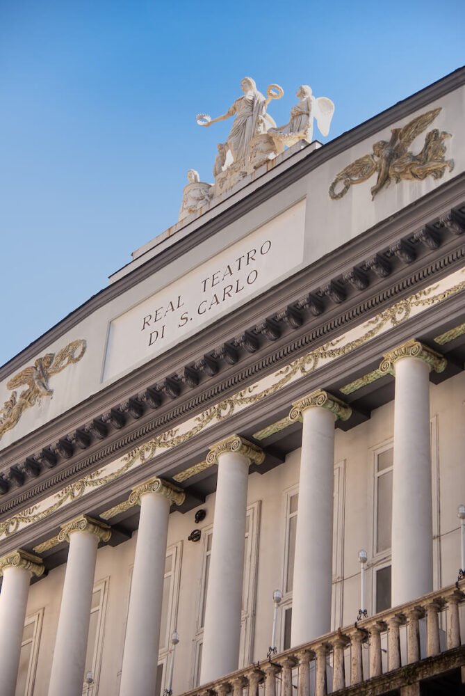 ornate detailing of the exterior of the Naples opera house called Teatro san Carlo on a sunny day