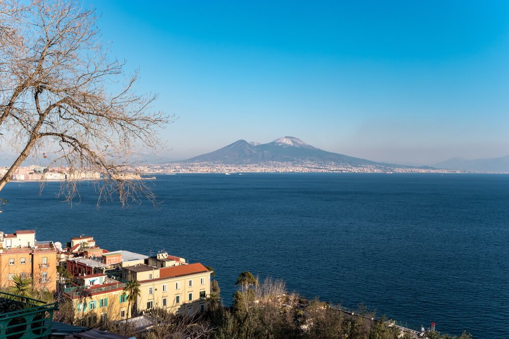 view of a snow capped volcano mt Vesuvius as seen from a hill in Naples in winter