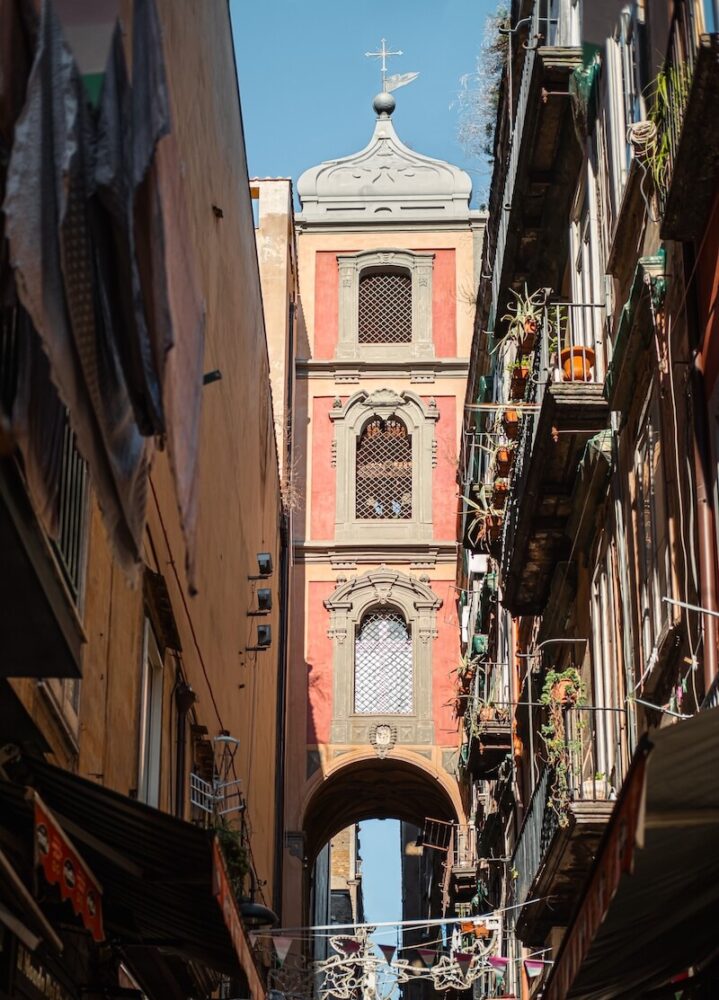 Pink-toned Bell Tower of the church of San Gregorio Armeno, which is located above Via San Gregorio Armeno. This famous narrow street has colorful displays of Nativity scenes in winter in Naples.