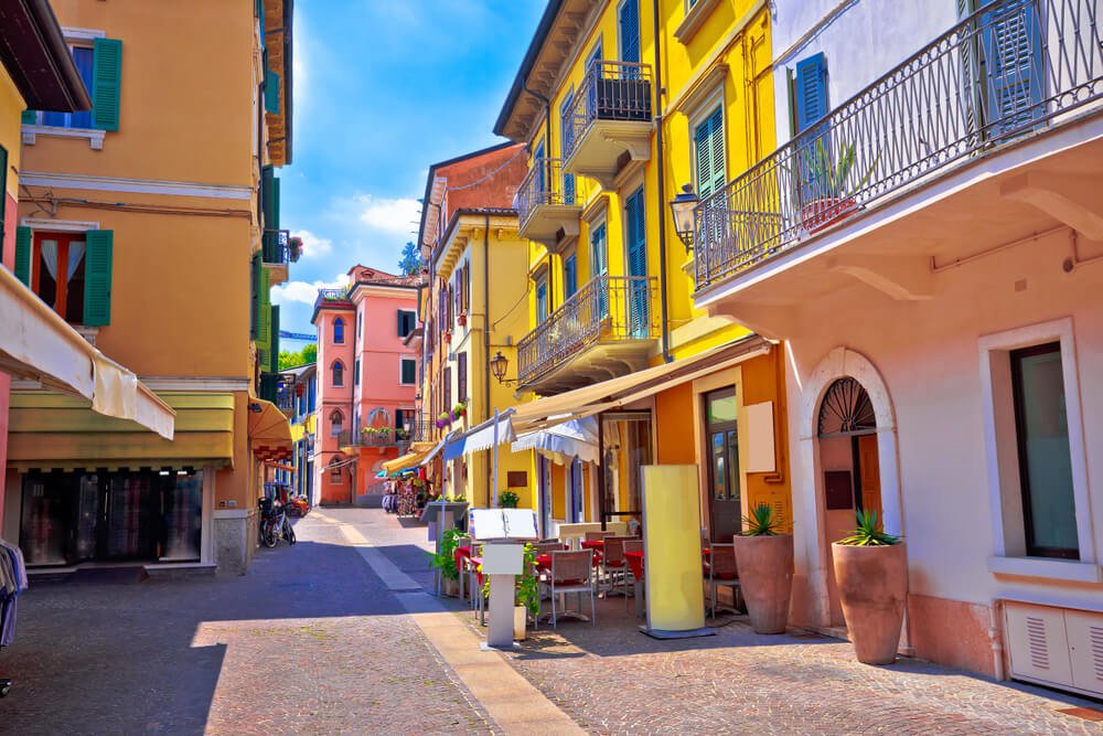 Yellow, pink and other pastel colored buildings in the colorful town of Peschiera del Garda