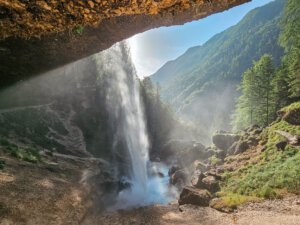 crushing waterfall with roaring waters seen from behind at the pericnik waterfall in Slovenia