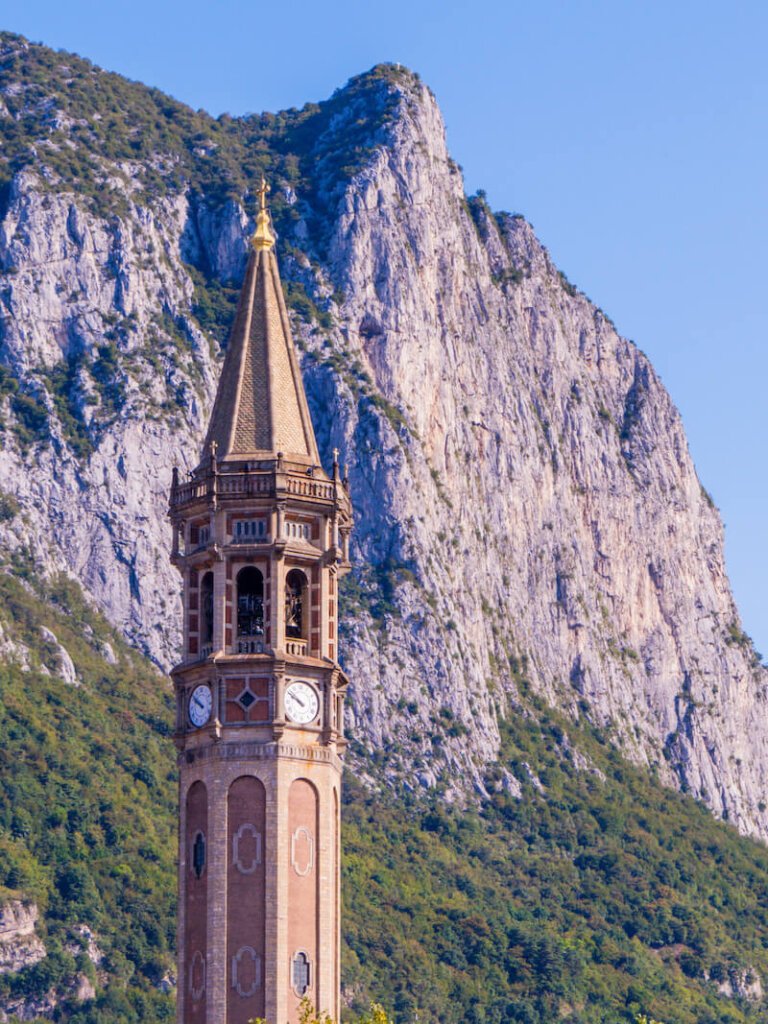 A close up of the clock on the bell tower in Lecco