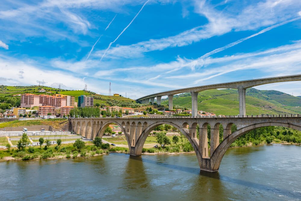Two bridges spanning the Douro River in the town of Peso da Regua, a charming winemaking town in the region of Douro valley