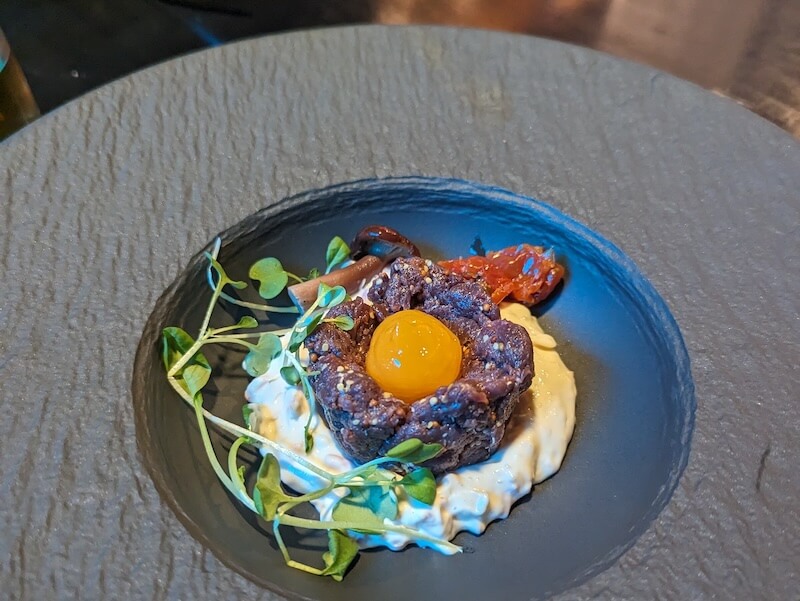 Reindeer tartar with raw egg and mayonnaise and watercress